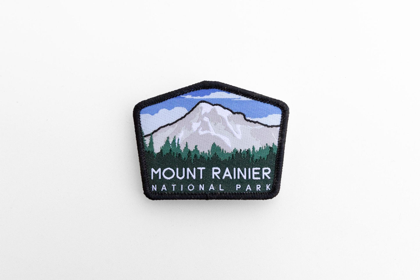 Small in a wide white frame, the Mount Rainier National Park patch shows its full five sided shape.