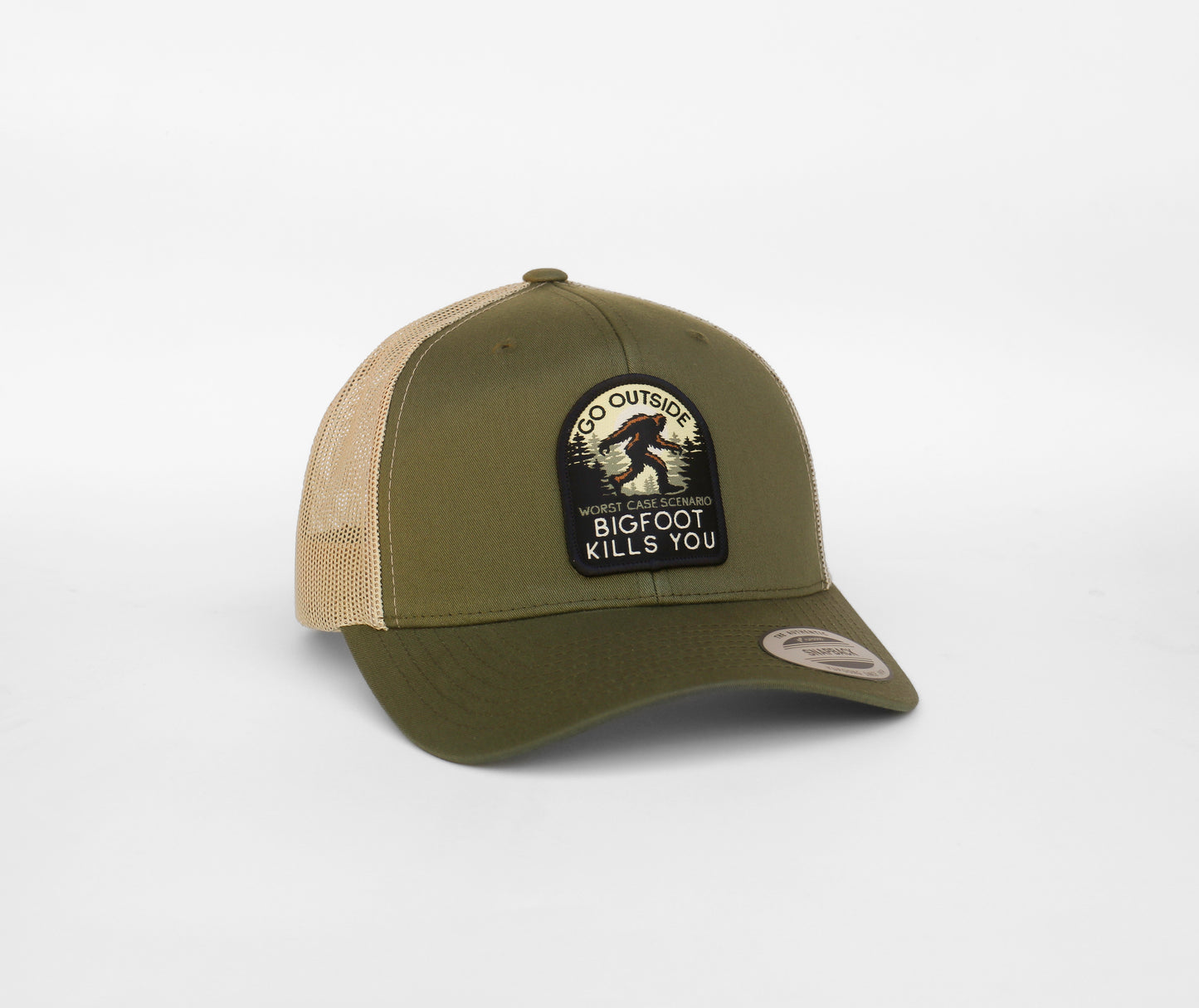 Army green front panel holds the Bigfoot Kills You patch on the trucker hat, khaki mesh wrapping the sides.