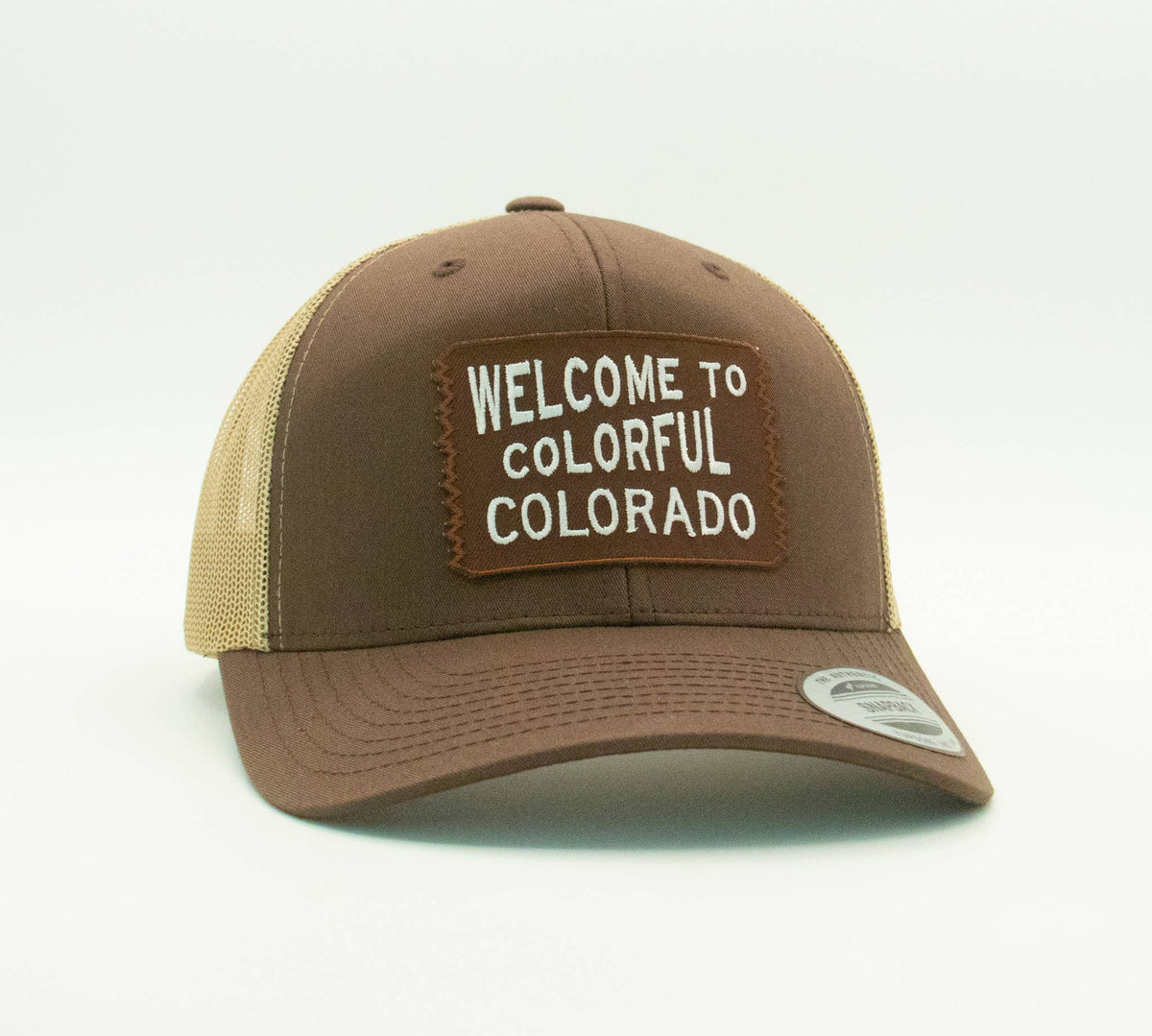 Brown Welcome to Colorful Colorado trucker hat pairs a matching patch with tan mesh side panels.