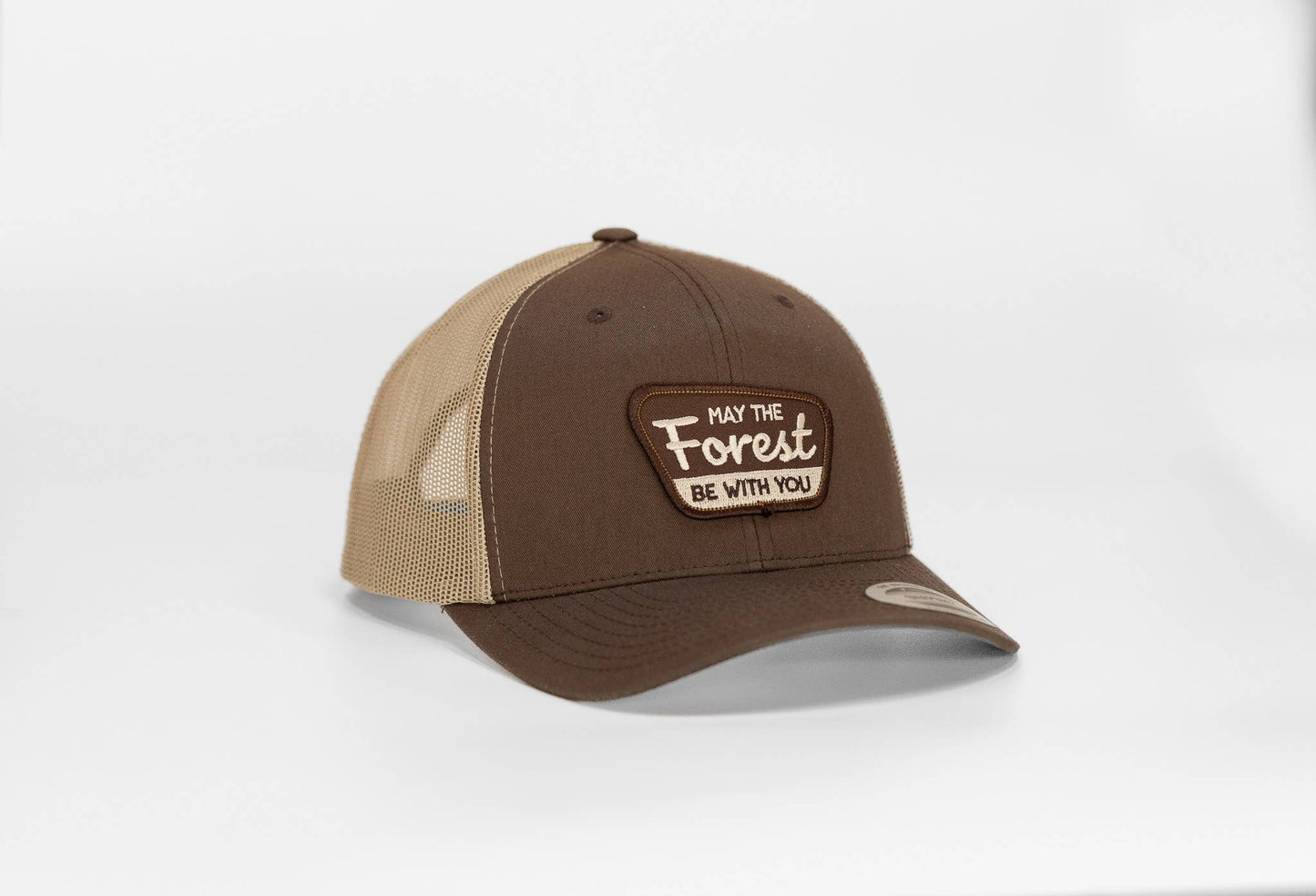 Brown crown and tan mesh on the May The Forest Be With You trucker hat, patch lettering in cream on white.