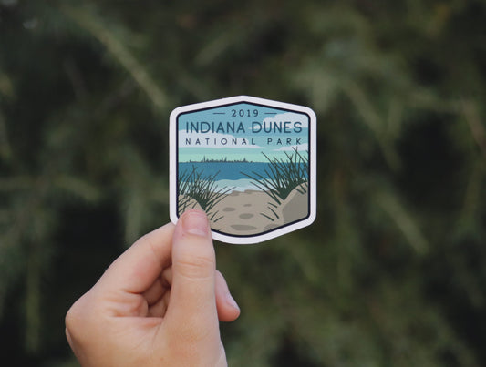 Pulled back a little, the same Indiana Dunes National Park sticker shows its beach grass, sand and lake skyline.