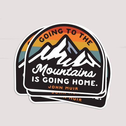 Three copies of the Going to the Mountains is Going Home sticker fanned in a small stack.