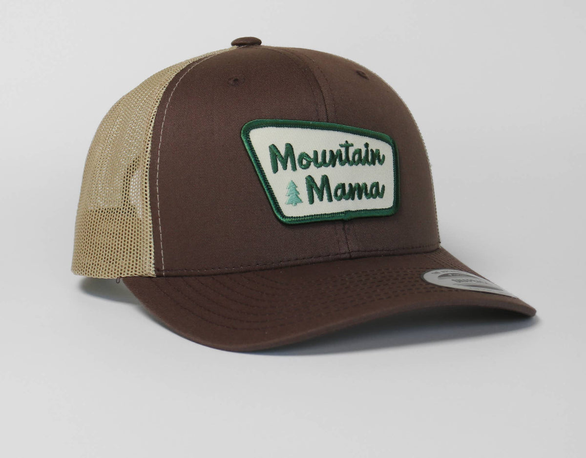Brown canvas and tan mesh make up this Mountain Mama trucker hat, the patch outlined in green thread.