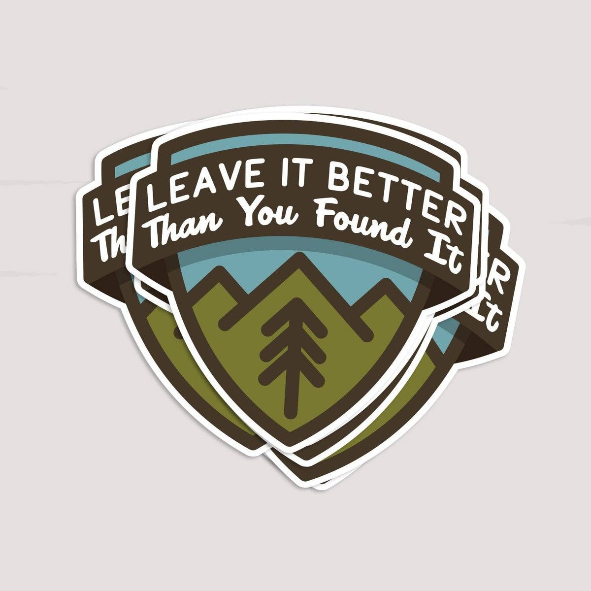 Three Leave It Better Than You Found It stickers overlap in a fanned stack on a pale grey surface.