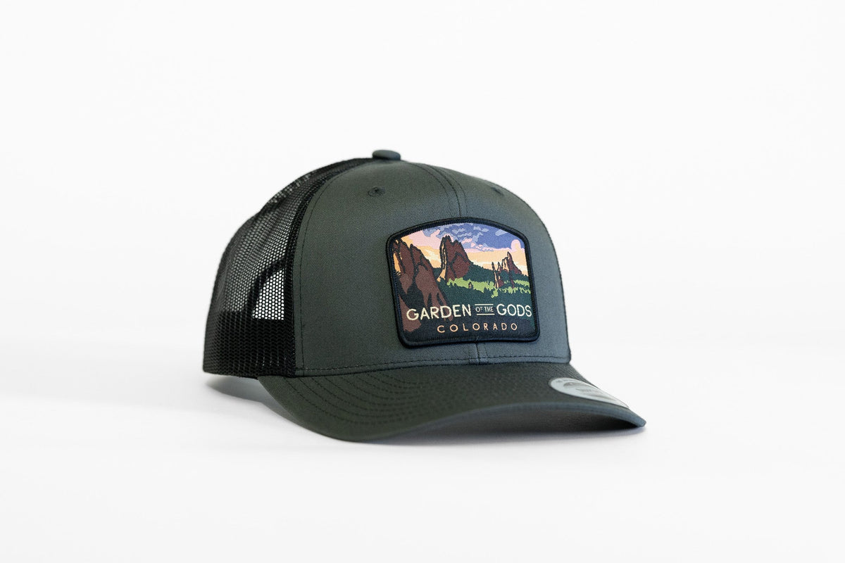 Dark forest green Garden of the Gods trucker hat with black mesh sides and the rock formation patch in front.