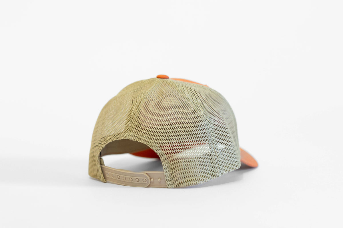Rear of the orange Bigfoot trucker hat, where khaki mesh meets a tan adjustable snapback strap.