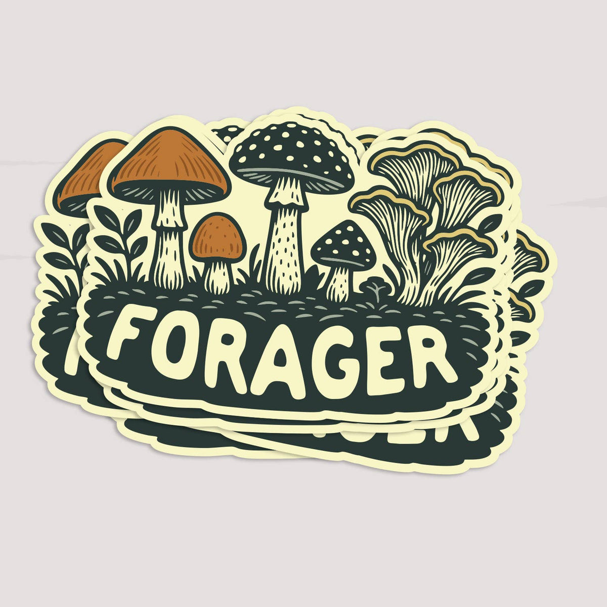 A stack of Forager Mushrooms stickers fans out on a pale grey surface, top one facing forward.