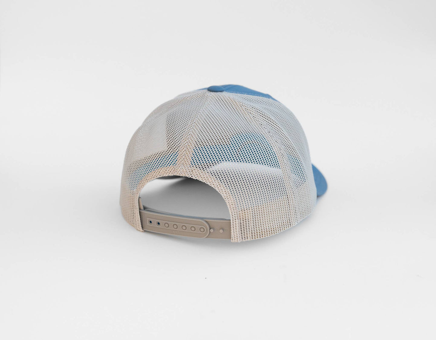 Seen from behind, the blue and birch Bigfoot UFO Conspiracy trucker hat shows a grey snap strap under tan mesh.