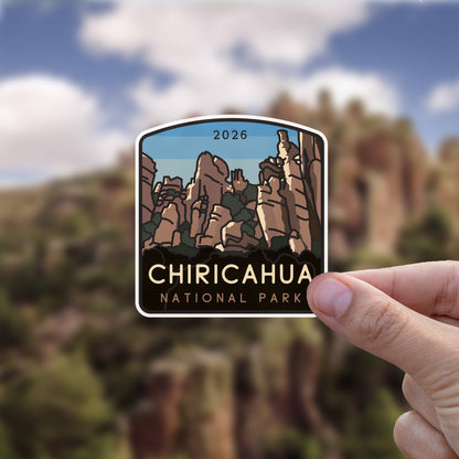 Held up against a blurred canyon landscape, the Chiricahua National Park sticker shows its own rock formations in miniature.