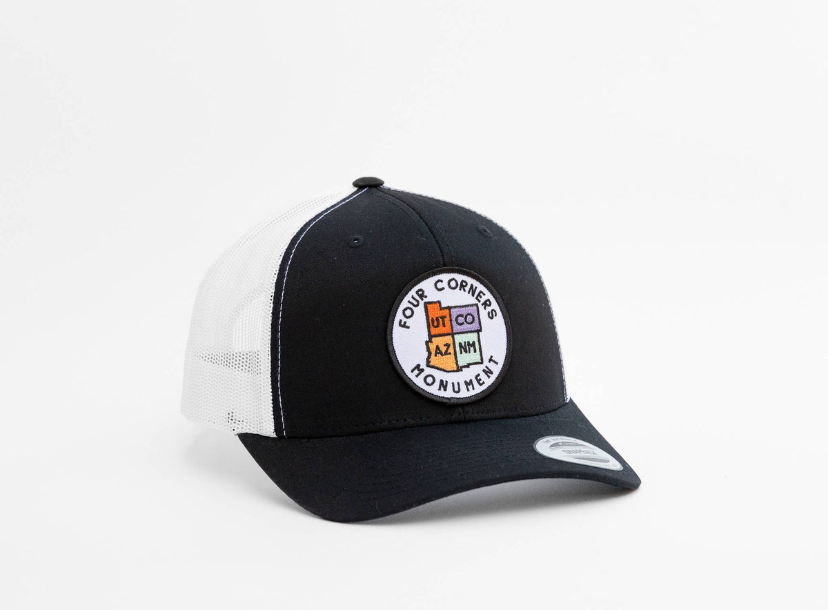 Black front panel and white mesh frame the state patch on the Four Corners Monument trucker hat.