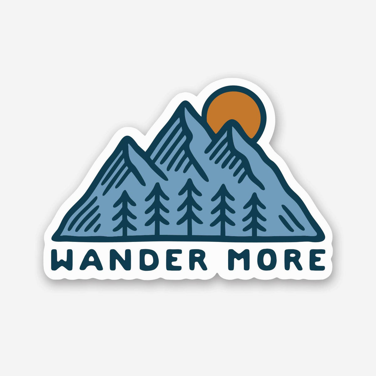 Blue peaks, pines and an orange sun fill the Wander More sticker on a plain white background.