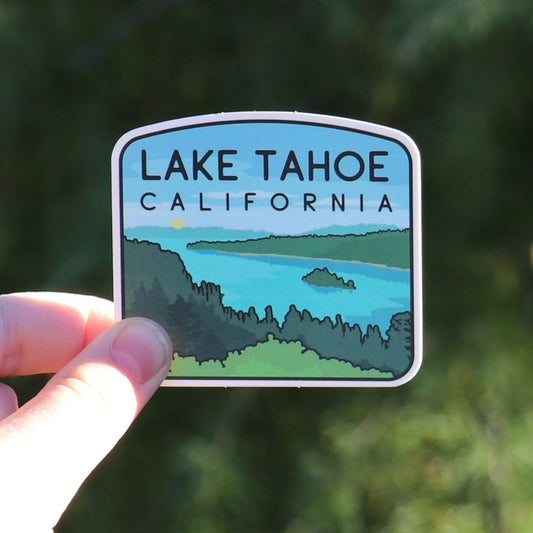 Held closer to the camera against evergreen branches, the Lake Tahoe sticker shows its California lettering clearly.