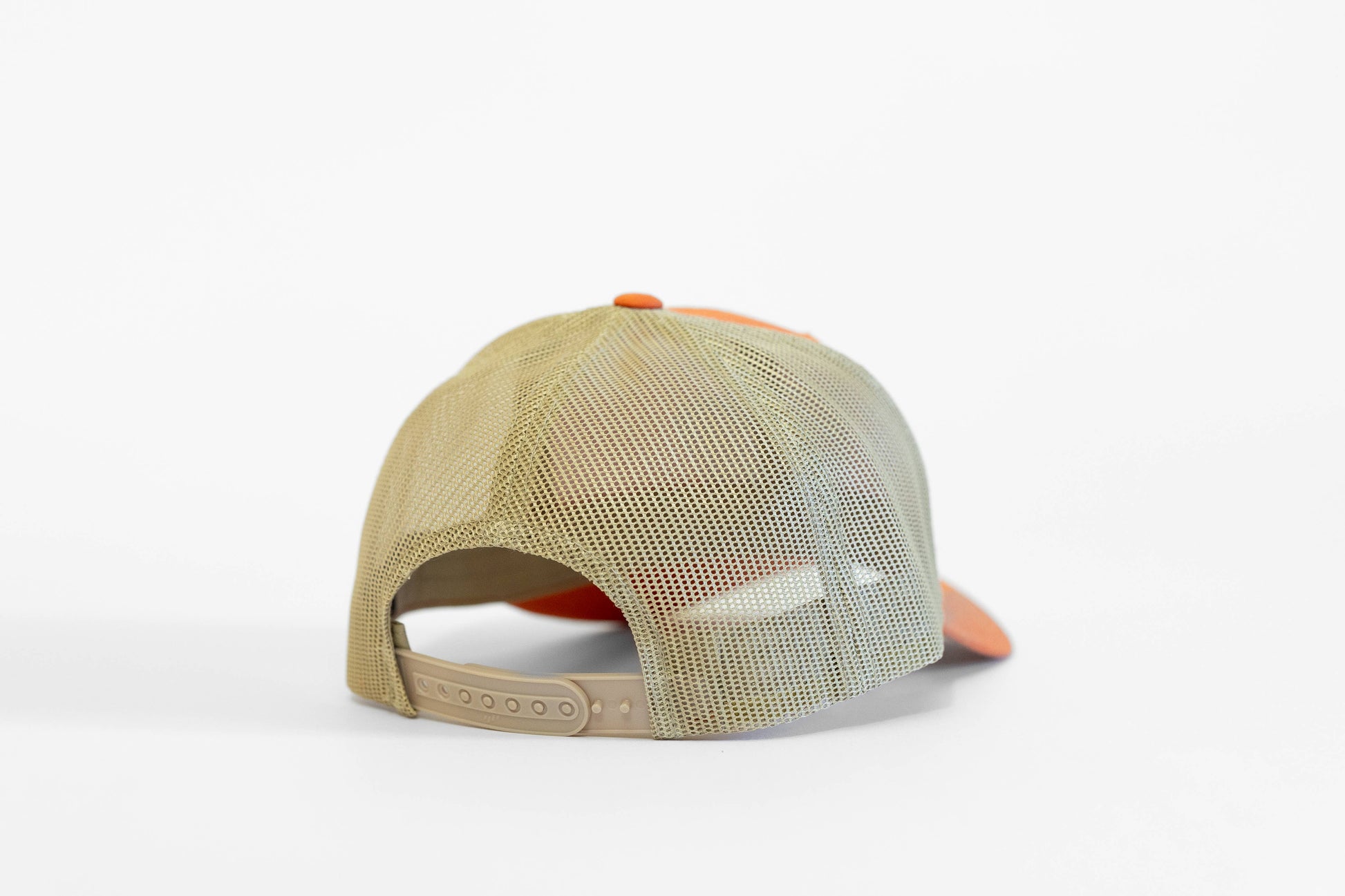 Seen from behind, the orange May The Forest Be With You trucker hat shows tan mesh and a beige plastic closure.