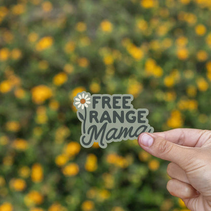 Held over a field of small yellow blooms, the Free Range Mama sticker shows its daisy and script.