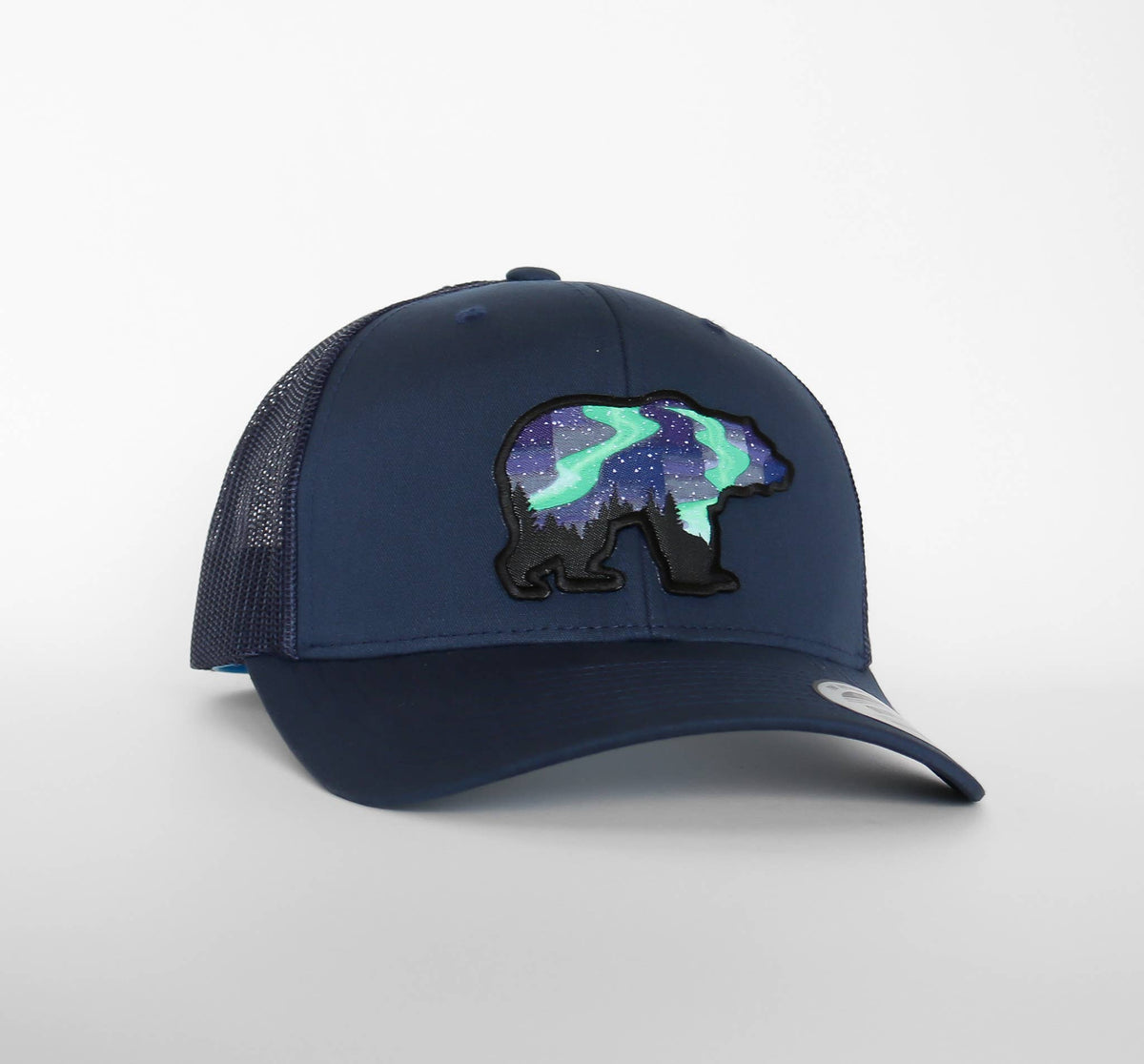 Navy blue Northern Lights Grizzly Bear trucker hat with the green and purple sky filling the bear shape.