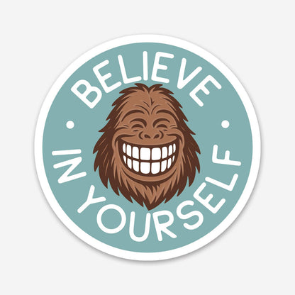 A grinning Sasquatch face fills the round teal Believe in Yourself sticker on a plain white background.
