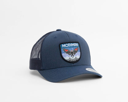 In navy with matching mesh, the Mothman trucker hat shows red eyes and a starry sky on its patch.