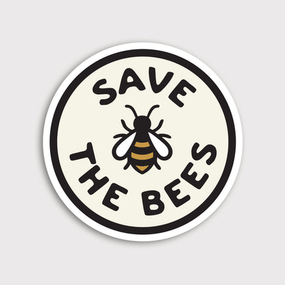 A round Save The Bees sticker shows a bee illustration between bold lettering on a cream circle with white border.