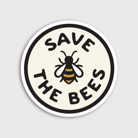 A round Save The Bees sticker shows a bee illustration between bold lettering on a cream circle with white border.