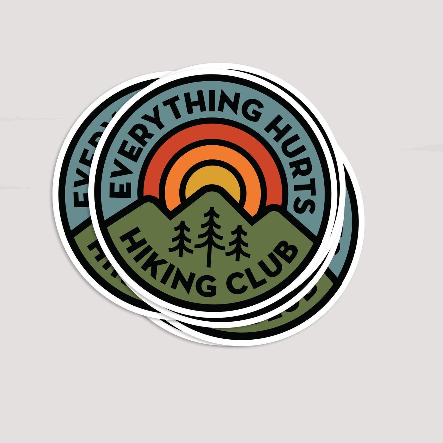 Two Everything Hurts Hiking Club stickers overlap on grey, the top one covering most of the one beneath.