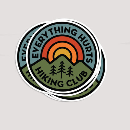Two Everything Hurts Hiking Club stickers overlap on grey, the top one covering most of the one beneath.