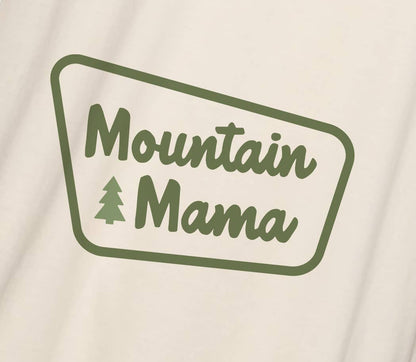 Close on the fabric, the Mountain Mama badge print sits in olive green ink with a small pine between the words.