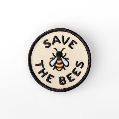 Centered on a plain white background, the Save The Bees patch shows its embroidered bee in gold, white and black.