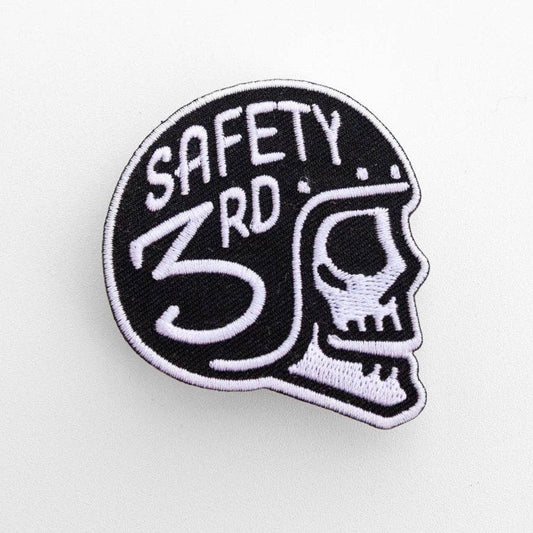 Filling the frame on white, the Safety 3rd Helmet Patch shows a white stitched skull in a black helmet.