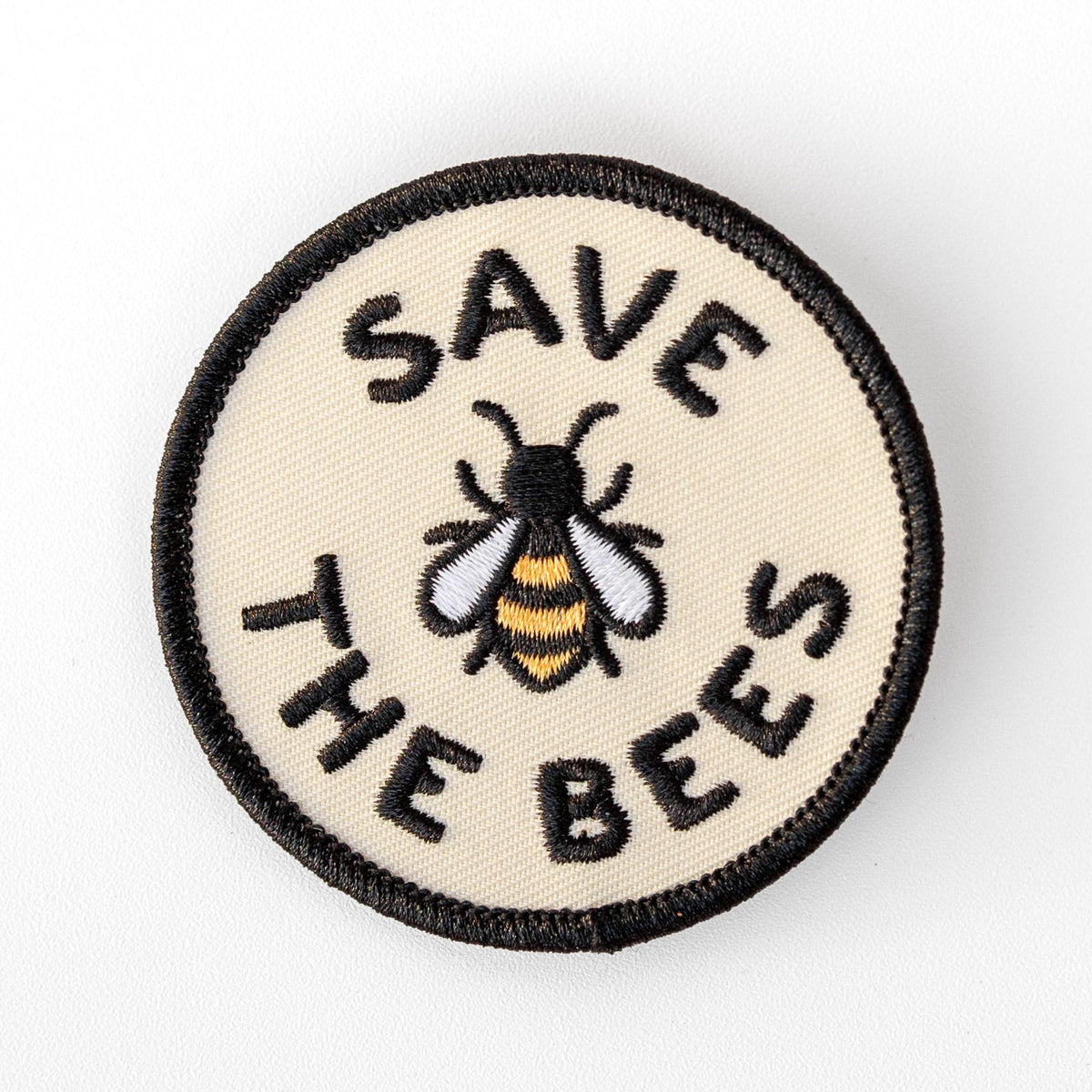 Centered on a plain white background, the Save The Bees patch shows its embroidered bee in gold, white and black.