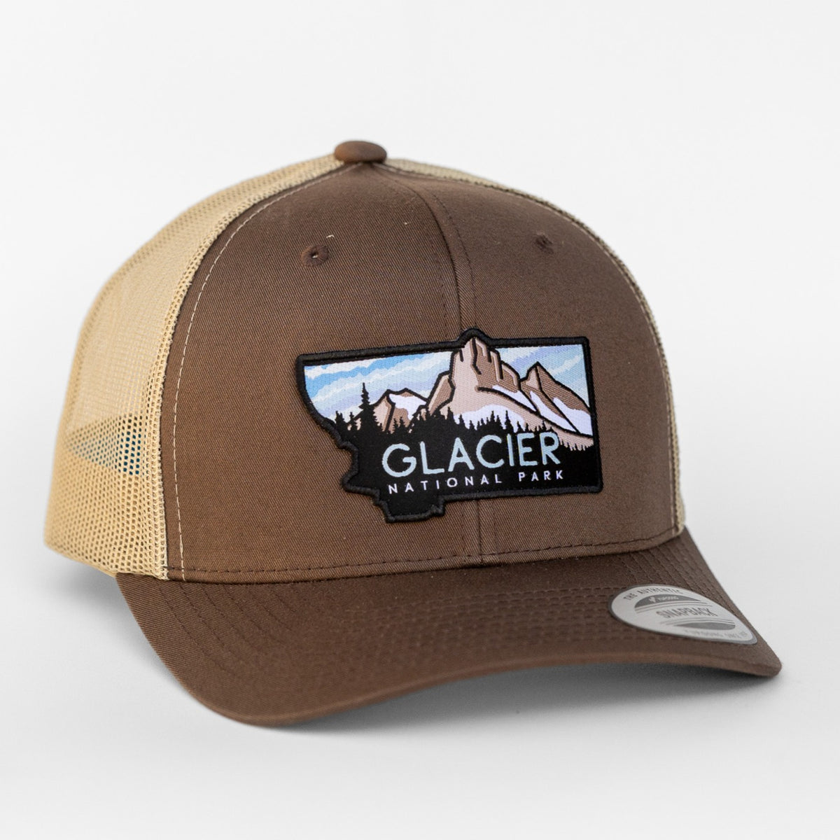 Brown fabric meets tan mesh on this Glacier National Park trucker hat, patch centered above the curved bill.