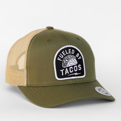 Olive green twill pairs with tan mesh on this Fueled By Tacos trucker hat, patch centered above the curved bill.
