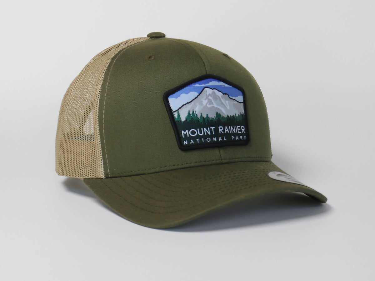 Olive green Mount Rainier National Park trucker hat with tan mesh sides and the same snowy peak patch.