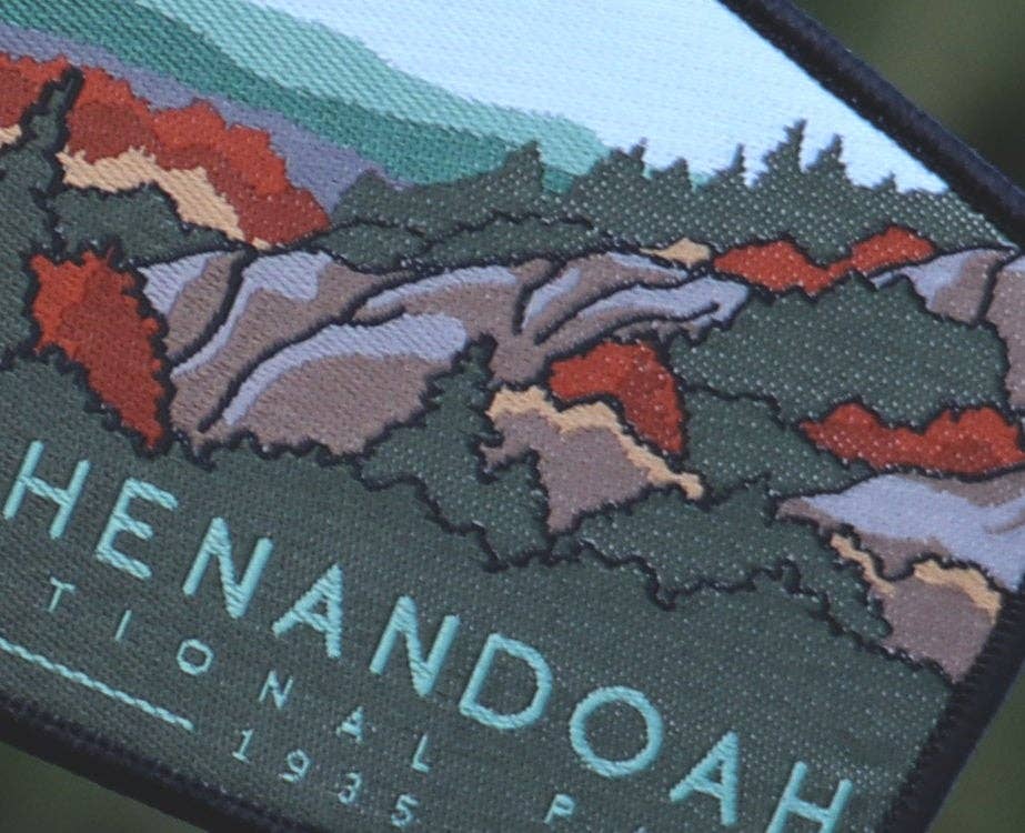 Close in on the stitching, red foliage and green ridges fill the Shenandoah National Park patch.