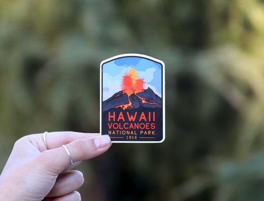 Held further back against dark foliage, the Hawaii Volcanoes National Park sticker shows its full arched shape.