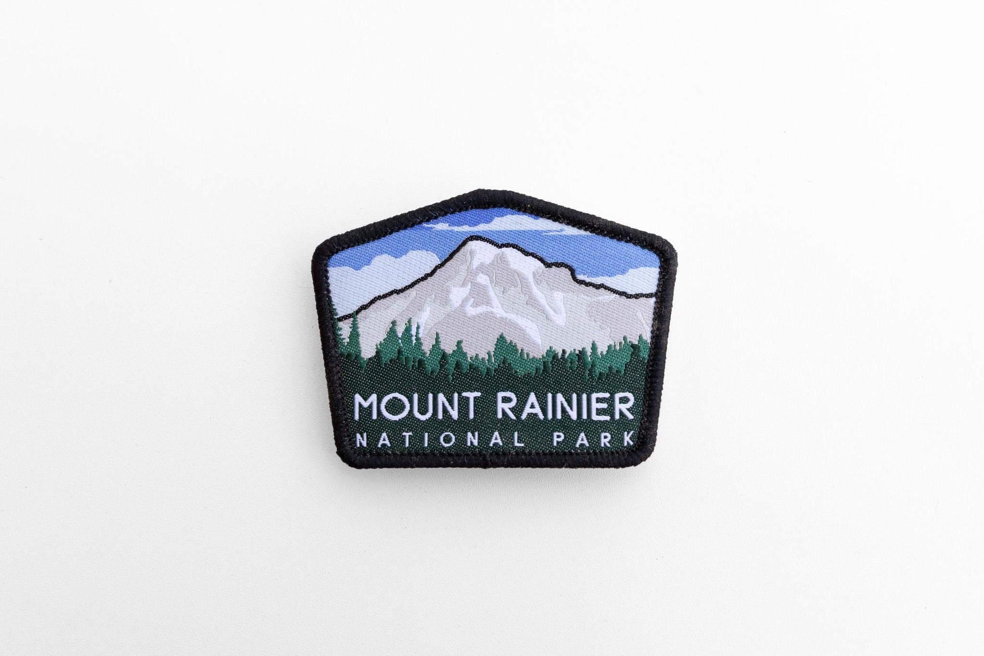 Small in a wide white frame, the Mount Rainier National Park patch shows its full five sided shape.