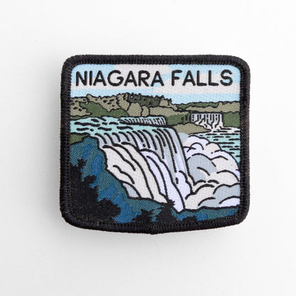 Flat on white, the Niagara Falls patch shows stitched waterfalls, blue water and black border lettering.