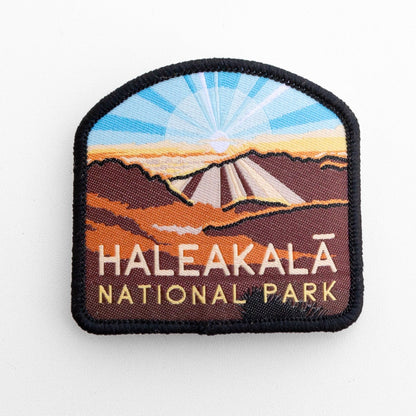 Flat on white, the Haleakala National Park patch shows a sunrise over the crater in stitched thread.