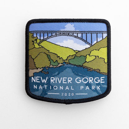 Flat on white, the New River Gorge National Park patch shows its steel arch bridge above green ridges and river.