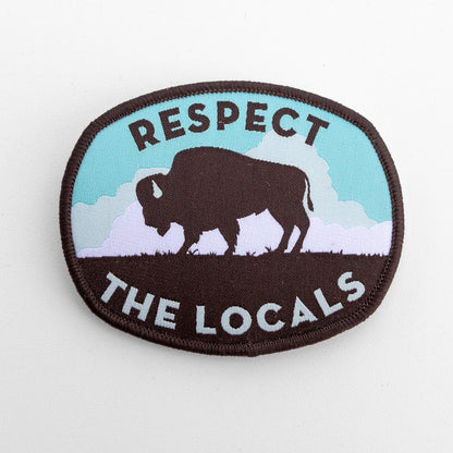 Close on white, the Respect The Locals bison patch shows its brown merrowed border and pale blue sky.