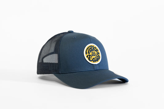 Navy Take it Easy trucker hat angled on white, its round patch reading Take it Easy in black script.