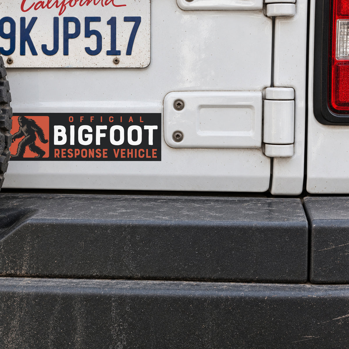 Mounted on a white Jeep's rear quarter panel, the sticker reads Official Bigfoot Response Vehicle near a California plate.