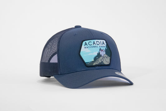 Navy Acadia National Park trucker hat in solid blue throughout, patch bright against the dark crown.