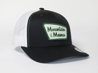 Black crown with white mesh sides on the Mountain Mama trucker hat, green script and small tree on the patch.