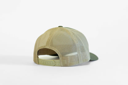 Rear of the olive and tan Safety Third trucker hat, snap strap unfastened and mesh catching soft light.