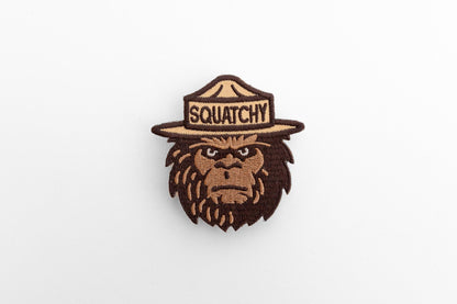 Laid flat and shot from above, the Squatchy patch fills the center of a bright white surface.