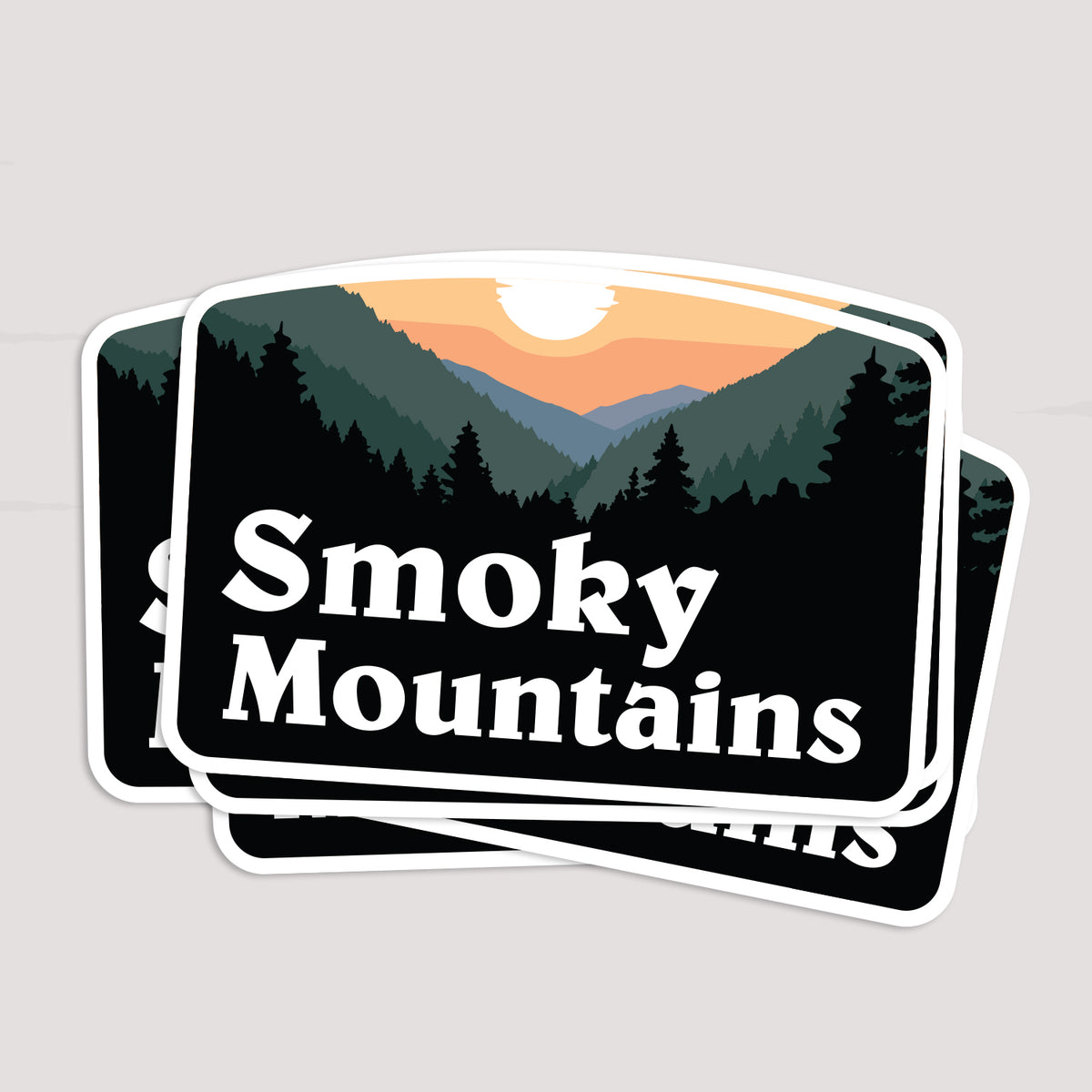 Two Smoky Mountains stickers lie stacked and slightly offset, showing the same sunset ridge artwork twice.