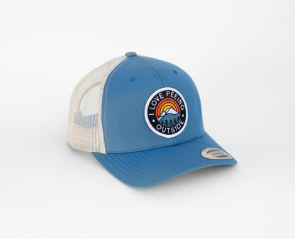 Steel blue I Love Peeing Outside trucker hat with cream mesh sides and the mountain patch front and center.