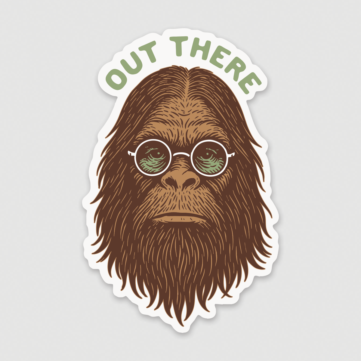 On a plain grey background, the Out There Sasquatch sticker shows a bearded bigfoot in round green glasses.
