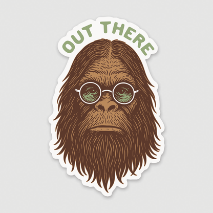 On a plain grey background, the Out There Sasquatch sticker shows a bearded bigfoot in round green glasses.