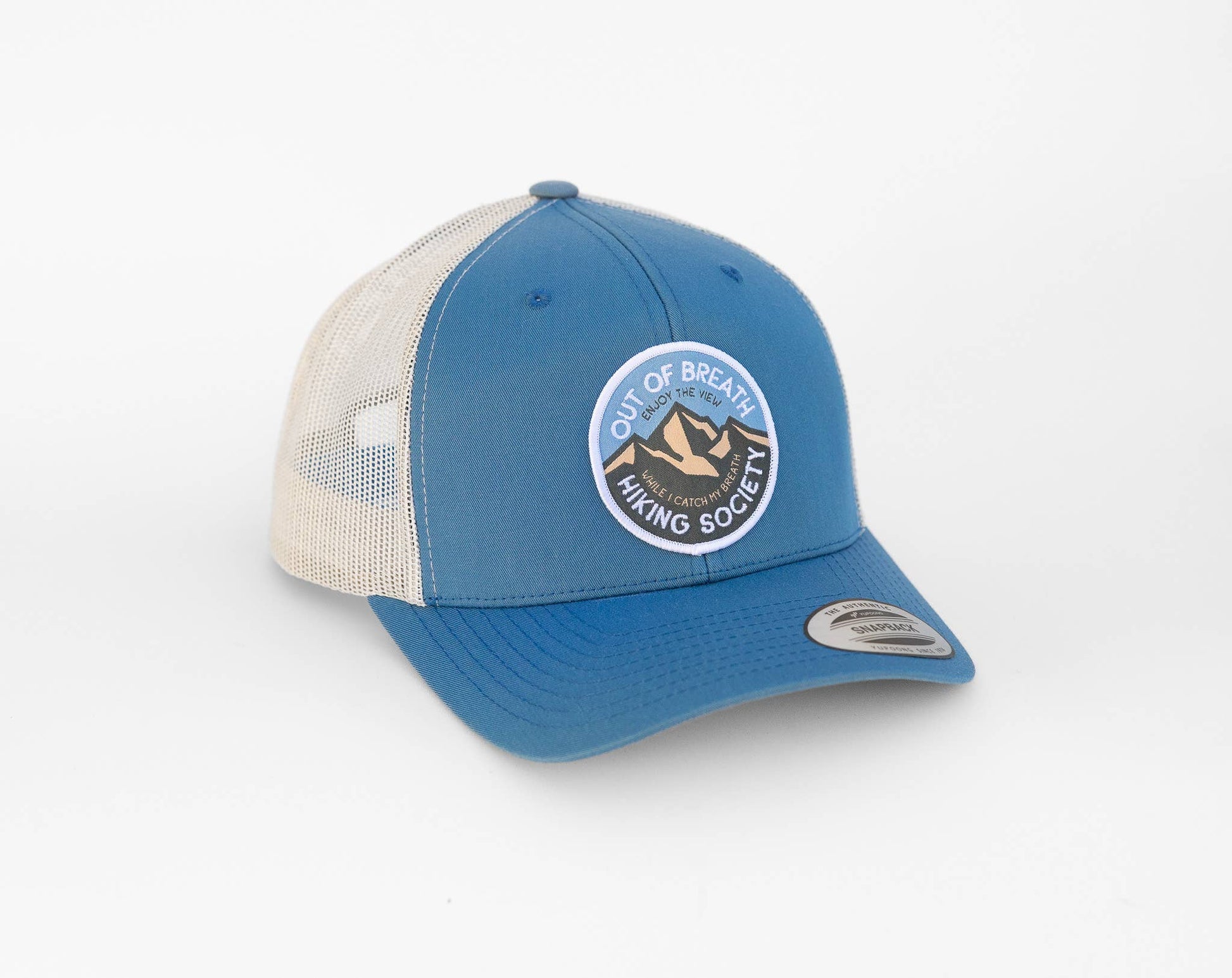 Steel blue front and stone mesh on the Out of Breath Hiking Society trucker hat, patch facing the camera.